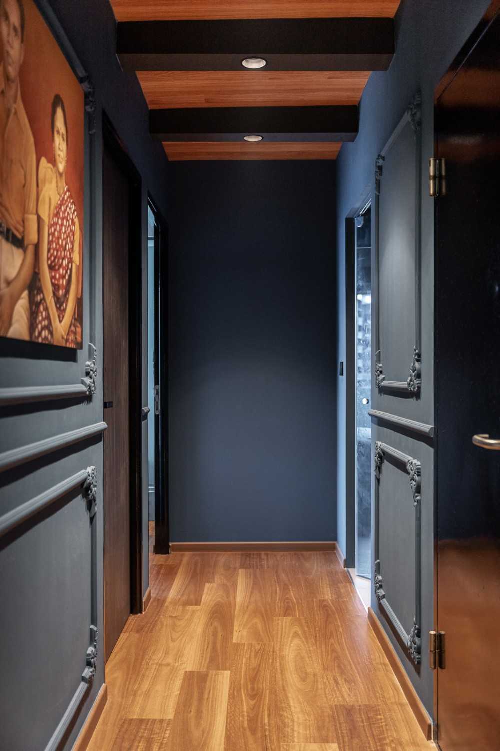 industrial hallway with drop ceiling and artwork