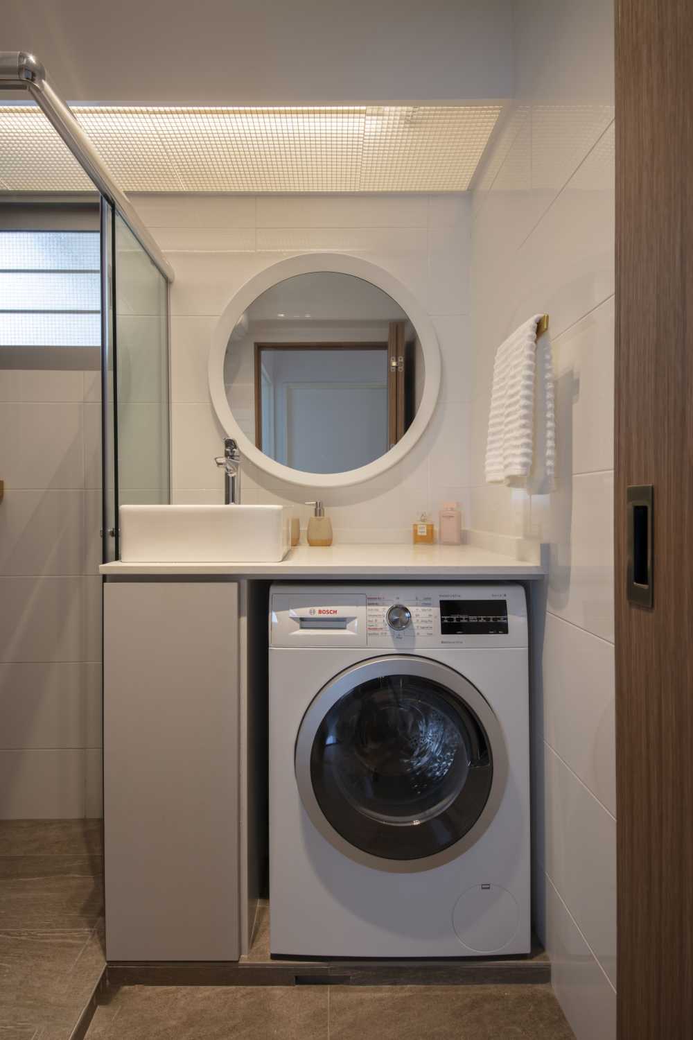 scandinavian bathroom with countertop and washing machine