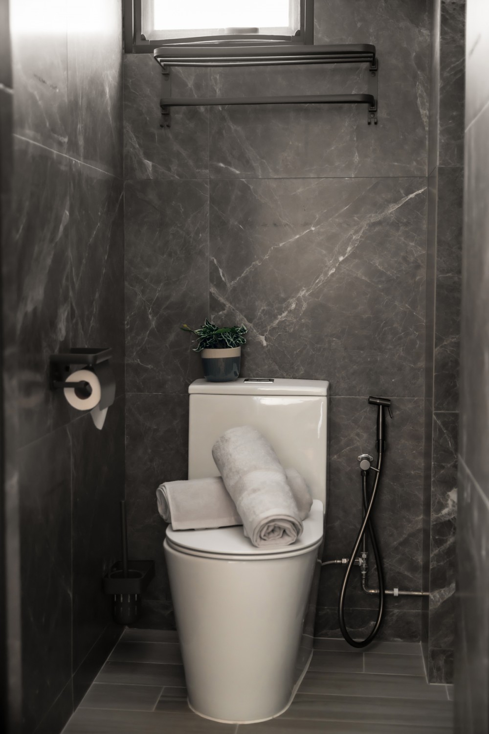 contemporary bathroom with homogeneous tiles and drying racks