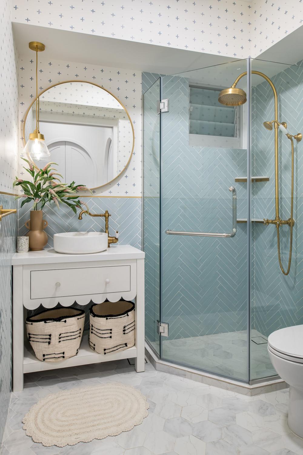 minimalist bathroom with herringbone tiling and mirror