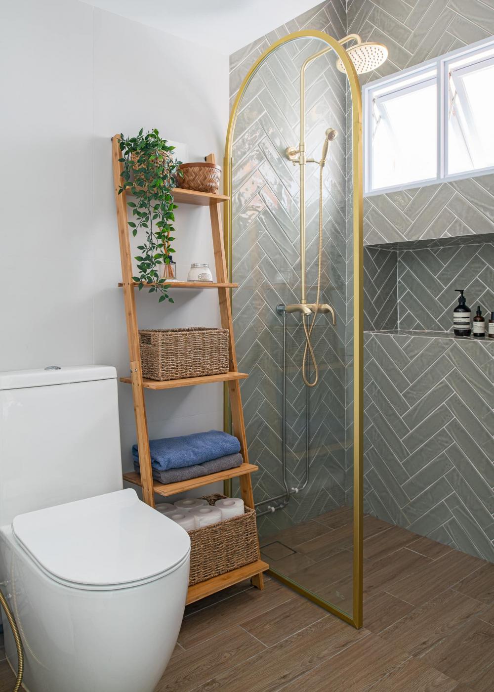 scandinavian bathroom with herringbone tiling and rainshower