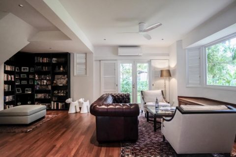 vintage living room with bookshelf and bay window